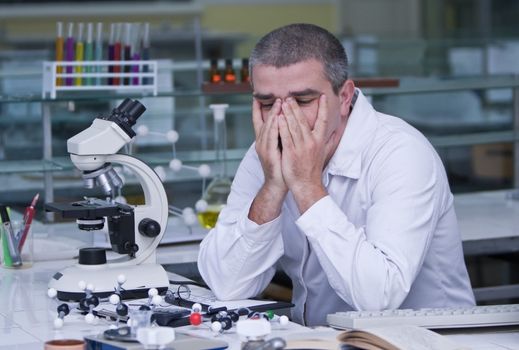 Tired researcher at his workplace.