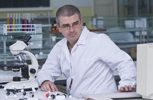 A researcher checking data on the computer computer at his workplace.