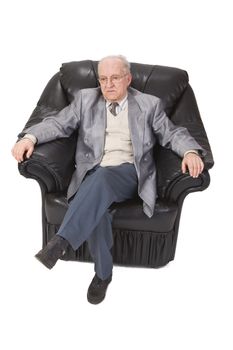 Inage of a senior man sitting in an armchair against a white background.