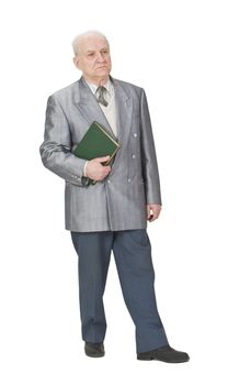 Senior man standing up an holding a book.