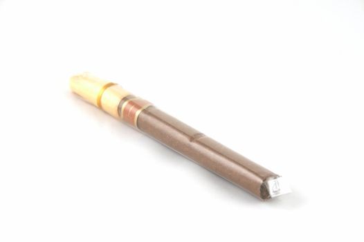 A cigar in polyethylene packing on a white background