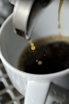 machine filling the white coffee cup