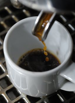 machine filling a white porcelain cup, Milan,Itay