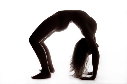 Studio portrait of a beautyfull blond naked model  making a bridge shape