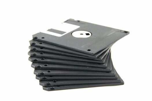 Pile of black diskettes on a white background.