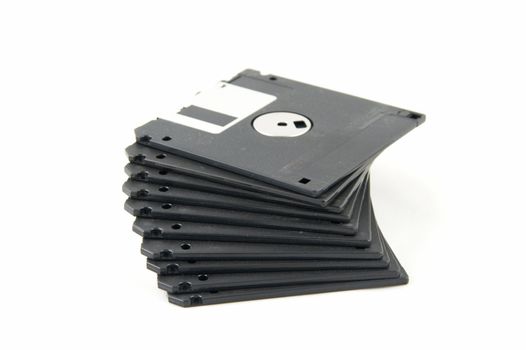Pile of black diskettes on a white background.