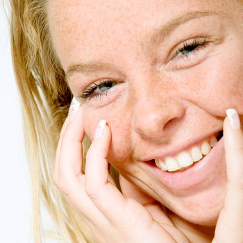 Studio portrait of a beautyfull blond model with a big toothy smile