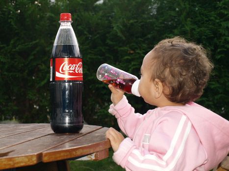 child drinking from bottle