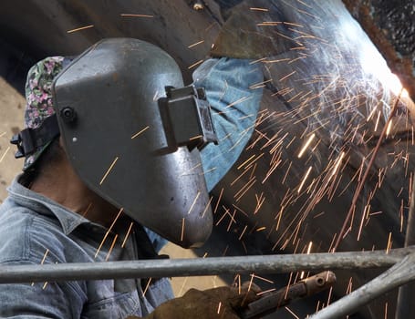 a metal welder busy at work