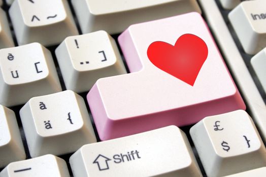 Heart on a pink computer enter key.