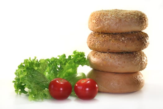 different bagel with a lettuce leaf and tomato