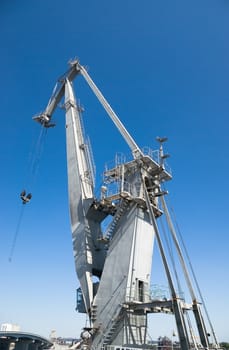 big harbor crane in the background of blue sky