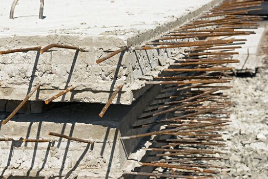 iron rods sticking out of concrete slabs