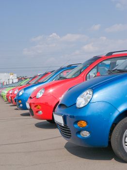 
A line of cars, all the same, parked side by side 