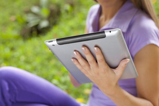 Beautiful Young Woman With Tablet Computer In Park