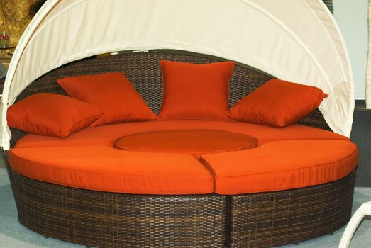 Round woven sofa with a canopy