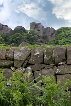 rock climbers climbing a rocky hill formation in the Cheshire countryside in England