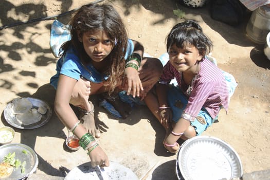 February 2010, Karla Caves India, children preparing lunch by the pavement