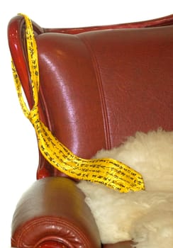 
yellow tie hanging from the back of the chair