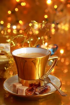 Coffee in gold cup with brown sugar and gold background