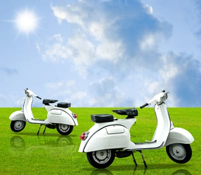 Vintage motorbike on grass with nice cloudy sky