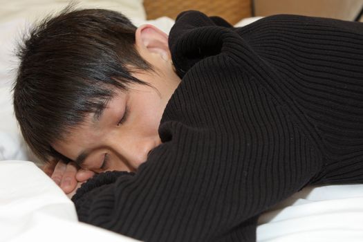 Man comfortably sleeping in his bed 