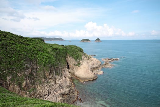coast, blue sky and green mountain