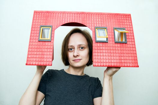 young women holds a roof. new house concept