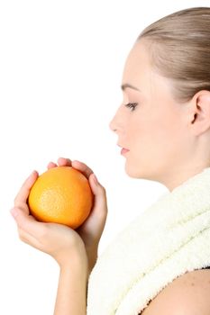 Beautiful young model holding an orange in her hands