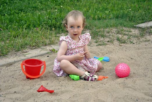 little girl playing in the sandbox