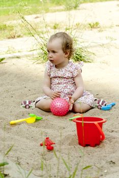 little girl playing in the sandbox
