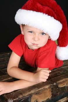 Cute boy with big blue eyes wearing a christmas hat