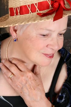 Beautiful female wearing a straw hat with red ribbon
