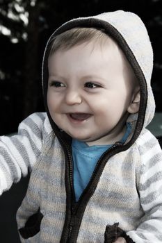 Baby boy playing outside in the garden wearing jersey