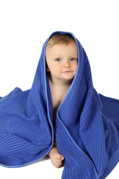 Beautiful baby boy wrapped in a soft blue towel