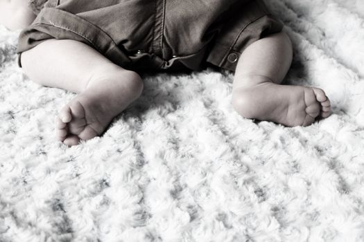 Newborn baby feet on a soft blanket
