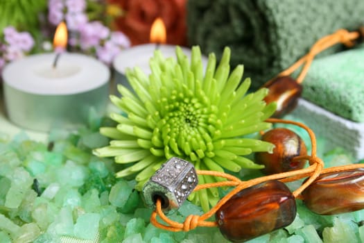 Spa Accessories setting with face cloths, jewelery and flowers 