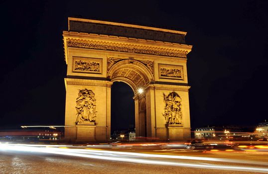 The Arc de Triomphe at night in Paris, France