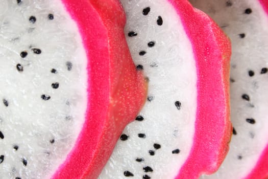 Pink pitahaya dragon fruit background sliced in pieces 