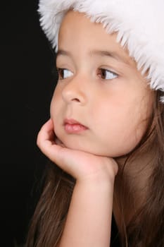 Beautiful little brunette girl dreaming about christmas