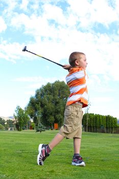 Young golfer playing a shot from the fairway