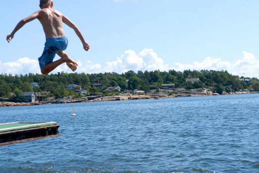 boy jumping into the sea. Please note: No negative use allowed.
