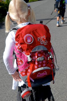 a girl with red schoolbag. Please note: No negative use allowed.