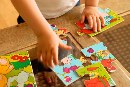 child playing puzzle. Please note: No negative use allowed.