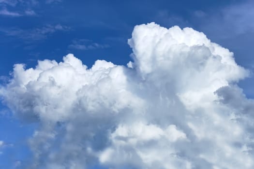 Thick white clouds against a background of a blue sky