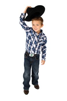 Young cowboy lifting his hat to greet someone