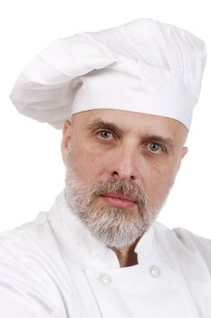 Portrait of a serious chef in a chef's hat.