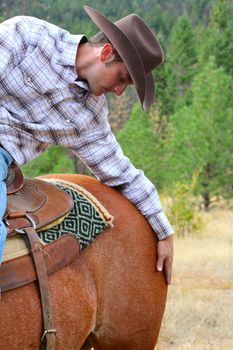 Passionate young cowboy spending time with his horse
