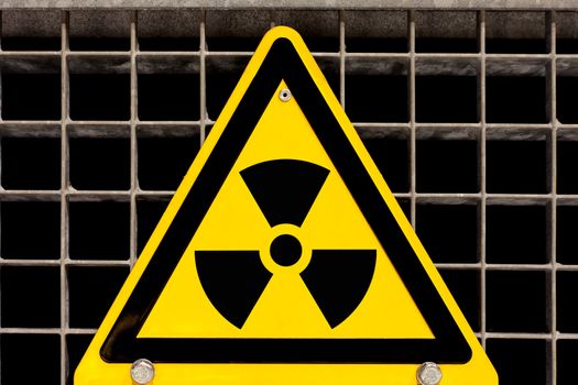 Nuclear radiation warning sign bolted to steel grid