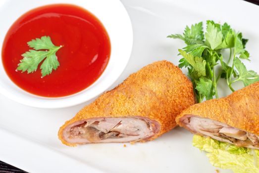 Closeup of rolls from pork meat, champignon mushroom, cheese and sauce